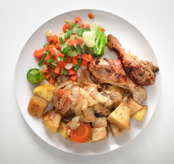plate of healthy food Baked chicken wings. baked vegetables for salad.