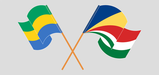 Crossed and waving flags of Gabon and Seychelles