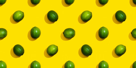Seamless pattern from limes on a yellow background.