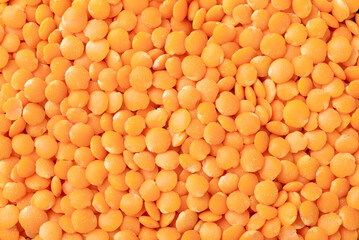 Top view, closeup of orange lentils. Food backdrop