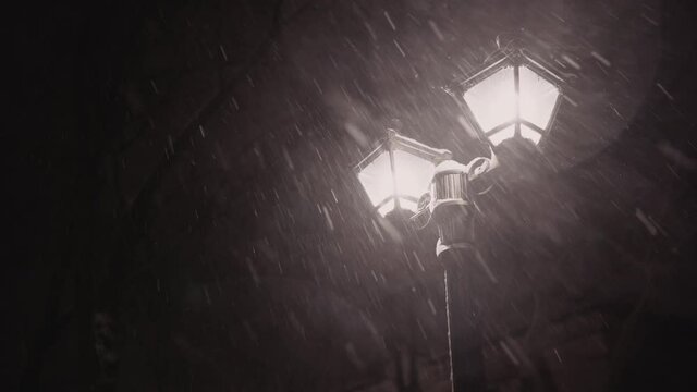 lantern on an alley in the city on a snowy winter night