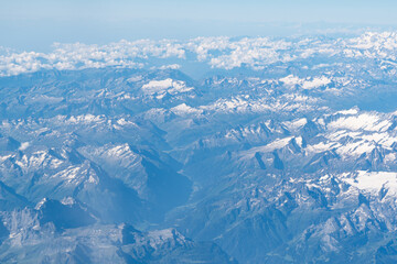 Obraz premium Beautiful View from airplane on the aircraft of the planet Earth cloudy landscape in sunny. Air travel and transportation concept.
