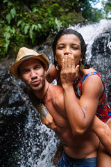 Young couple in love at the waterfall in Costa Rica