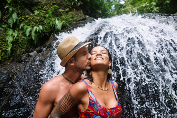Young couple in love at the waterfall in Costa Rica