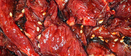 Bright, juicy marinated slices of beef with spices, oil and sesame seeds