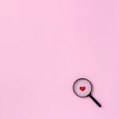 Magnifying glass and decorative red heart. Love search concept. Square orientation, place for text.