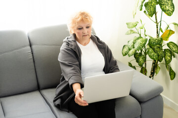 Elder woman using a laptop computer at home