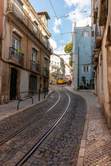 Naklejka na ściany i meble Lisboa famous tram captured in movement in a sunny day. Lisbon, Portugal
