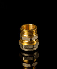 Brass fitting on a black background. Often used in plumbing and gas installations