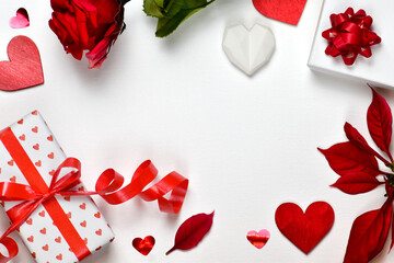 Valentine's Day background. Red hearts, gifts and rose on white background. 
