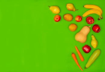 Flat lay composition with fresh organic fruits and vegetables for first baby food on green background. Top view. Healthy child nutrition, baby feeding. Copy space. Diet and vegetarianism. 