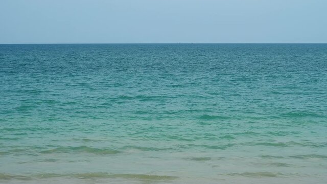Beautiful colored water of tropical sea change from green to blue shades with distance. Ripply surface seen to horizon. Pure tropical nature at exotic islands of Thailand