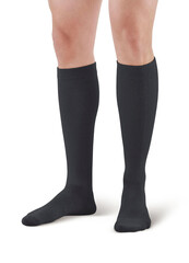 Black color socks isolated on white background. One pair of socks. Set of black socks for sports on foot as mock up for advertising, branding, design mockup, isolated, clipping path.