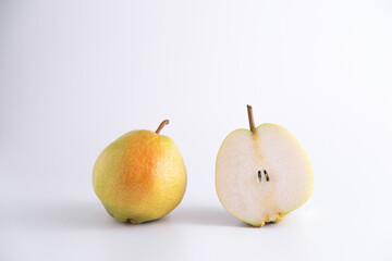 Isolated single and sliced fresh pears over white studio with copy space and vivid image