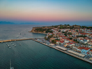 Naklejka na ściany i meble Aerial view over Koroni seaside city at sunset. Koroni, Messenia, Greece