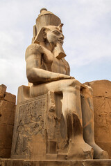 Huge statue of sitting Ramses III pharaoh in Karnak temple