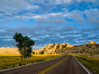 Road leading into Badlands National Park at sunrise