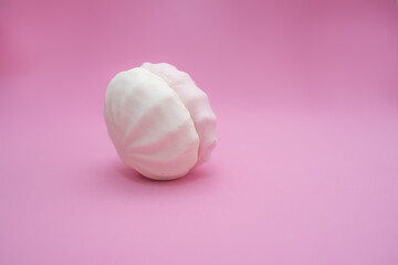 Marshmallow from two halves on a pink background