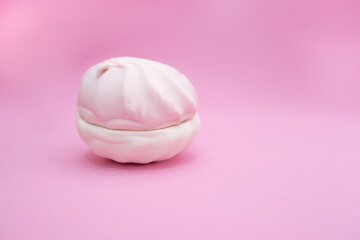Marshmallow from two halves on a pink background