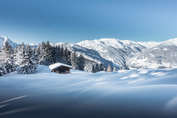 herrliche Winterlandschaft mit Skihütte in den Alpen