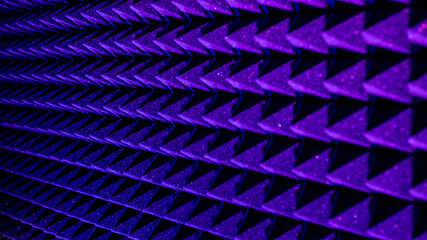 Background image of recording studio sound dampening acoustical foam.
