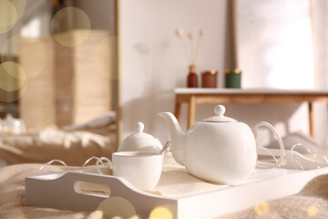 Fototapeta na wymiar White tray with ceramic tea set in room