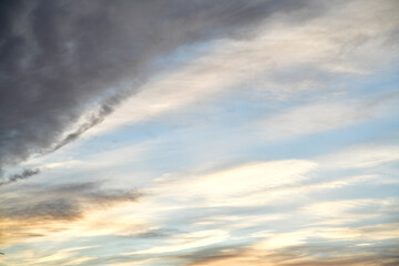 pre-sunset view of the sky with dark silhouettes of houses