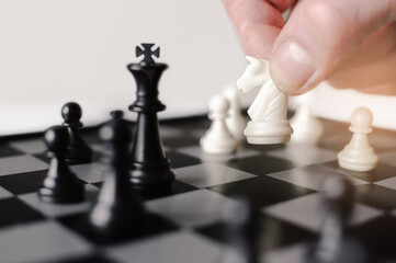 Businessman makes a khight move. Chess game for a successful plan and strategy.
