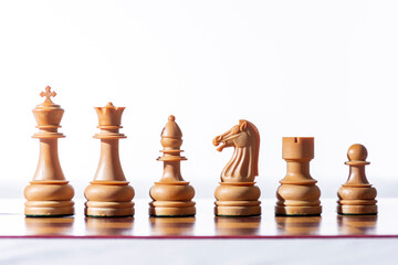 Chess. White chess pieces on chessboard with white background.