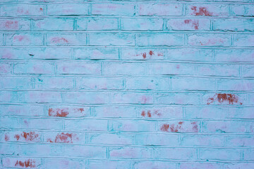 Red brick wall painted turquoise, close-up. Red brick wall with teal paint, background