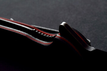 frame-lock of folding knife on black background