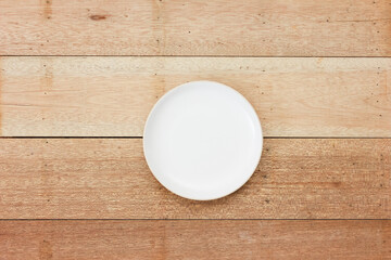 Plate to put food on it with wooden background.