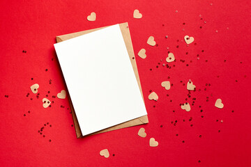 Greeting card with copy space and small hearts on red paper background