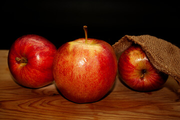 Appetizing succulent apples ready to eat on wooden board