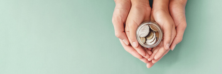 child and parent hands holding money jar,fundraising charity, donation, saving, family finance plan...