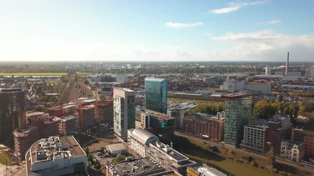 Aerial tilting view of office buildings and Dusseldorf Hamm train station in central city area next to Rhine river