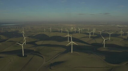 Aerial windmill farm aeolian sustainable energy sideways dolly day