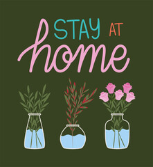 stay at home lettering and plants inside a pots