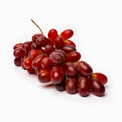 red grapes on a white background with reflected shadows