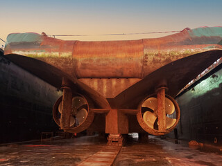 Industry view - Ocean Vessel in the dry dock in shipyard. Old rusty ship under repair. View from...