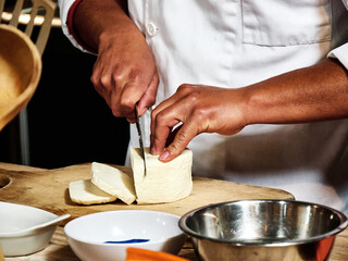 Hands of man taking a cut salad