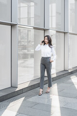 businesswoman talking on cell phone while walking