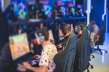 Cyber sport e-sports tournament, team of professional gamers, close-up on gamer's hands on a keyboard, pushing button, gamers playing in competitive moba, strategy fps game in a cyber games arena club © tsuguliev