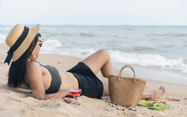 woman in black swimsuit relaxing on the beach