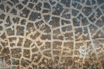 Stone wall texture. Cracked spotted gray cement floor background with rough texture.
