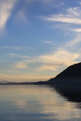 Peaceful Sunset in the lake with a reflection of a mountain