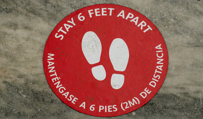A ground sign marks six feet in English and Spanish so New Yorker's can remain socially distanced...