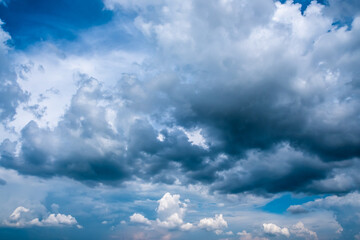 Blue sky with clouds. Dramatic overcast cloudy sky filled with cumulonimbus clouds in rainy season.
