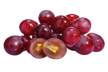 a bunch of ripe red table grapes and nearby lying halves of grapes on a white isolated background close-up