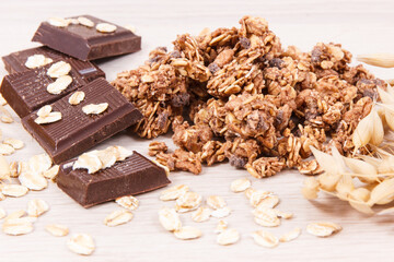 Granola oat flakes and chocolate containing iron and fiber, healthy snack concept